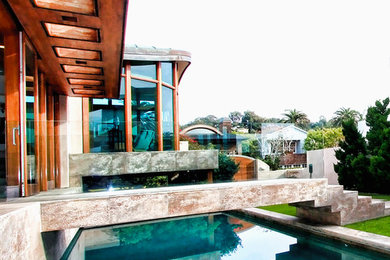 Inspiration for a large modern backyard infinity pool remodel in San Diego