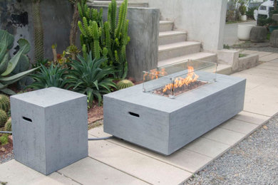 Inspiration for a small modern backyard concrete paver patio remodel in Toronto with a fire pit