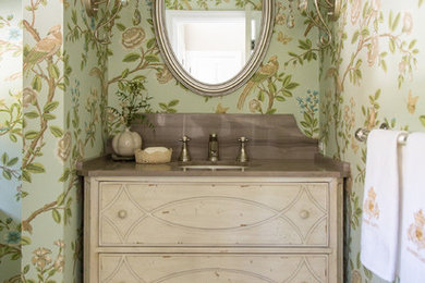 Powder room - shabby-chic style ceramic tile powder room idea in Los Angeles with an undermount sink, furniture-like cabinets, light wood cabinets, green walls, marble countertops and brown countertops
