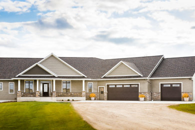 Example of a mid-sized classic beige one-story mixed siding house exterior design in Other