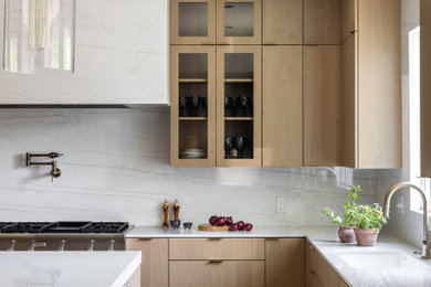 Open concept kitchen - large contemporary u-shaped medium tone wood floor and brown floor open concept kitchen idea in DC Metro with an undermount sink, flat-panel cabinets, medium tone wood cabinets, quartz countertops, white backsplash, quartz backsplash, paneled appliances, an island and white countertops