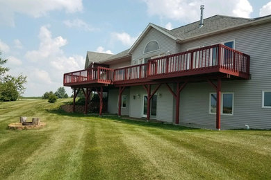 Large elegant backyard deck photo in Other with no cover