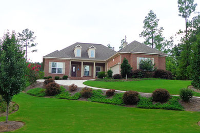 This is an example of a large traditional full sun hillside driveway in Atlanta.
