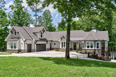 Example of a large arts and crafts gray two-story concrete fiberboard and board and batten exterior home design in Atlanta with a shingle roof and a brown roof