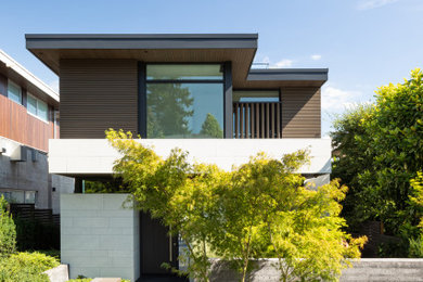 Trendy gray three-story mixed siding flat roof photo in Vancouver with a mixed material roof