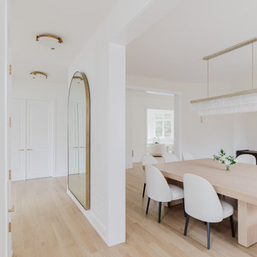Modern Dining Room with Custom Oak Table and Arched Entryway
