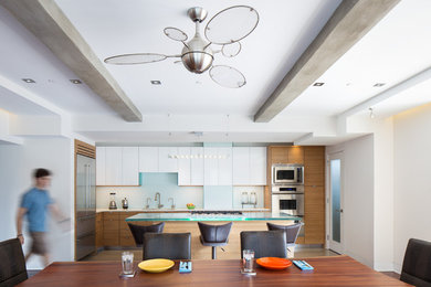 Design ideas for a contemporary kitchen in Philadelphia with an undermount sink, flat-panel cabinets, white cabinets, blue splashback, stainless steel appliances and with island.