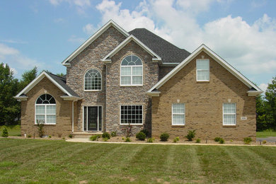 Large beige two-story mixed siding exterior home idea in Other
