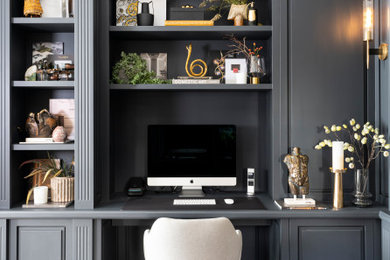 This is an example of a contemporary home office in London with dark hardwood flooring and brown floors.