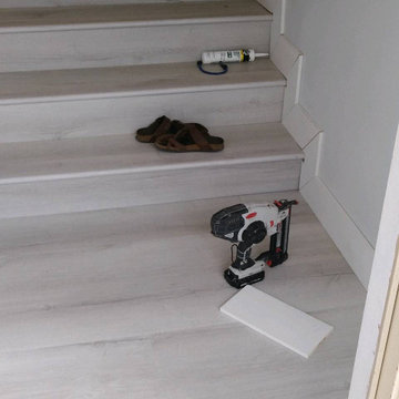 Installation of Tile and baseboards on stairs.