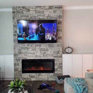 TV Over a Linear Fireplace Design with Arctic Smoke Stacked Stone