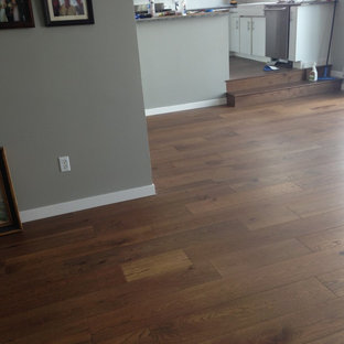 Design ideas for a mid-sized arts and crafts open plan dining in Minneapolis with grey walls, medium hardwood floors and no fireplace.