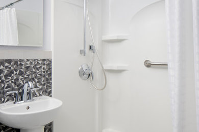 Example of a trendy black and white tile bathroom design in San Francisco with a two-piece toilet, white walls and a wall-mount sink