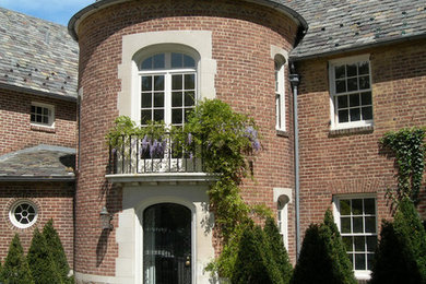 Inspiration for a large timeless brown two-story brick exterior home remodel in Bridgeport