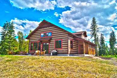 Example of a mid-sized mountain style brown two-story wood exterior home design in Other with a shingle roof