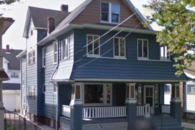Example of a transitional blue two-story wood gable roof design in Cleveland