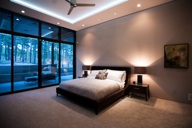 Photo of a large contemporary master bedroom in Denver with grey walls, carpet, no fireplace and brown floor.