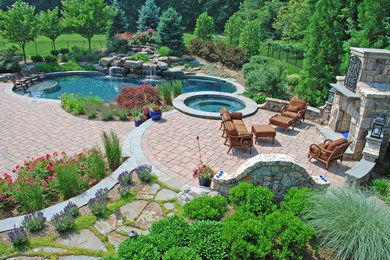 Inspiration for a large timeless backyard brick patio remodel in New York with a fire pit and no cover