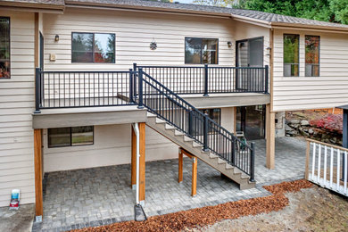 Deck - mid-sized modern backyard second story metal railing deck idea in Seattle