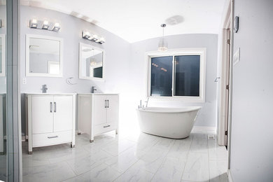 Inspiration for a large contemporary master glass tile freestanding bathtub remodel in Toronto with flat-panel cabinets, a two-piece toilet, gray walls and an undermount sink