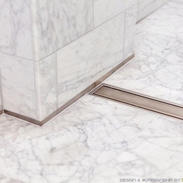 White marble curbless bathroom with linear drain