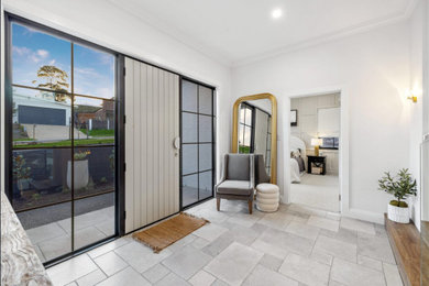 Design ideas for a mid-sized transitional foyer in Adelaide with white walls, travertine floors, a single front door, a white front door and grey floor.