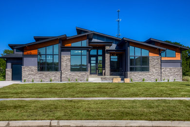 Large minimalist blue two-story mixed siding house exterior photo in Other with a shed roof and a shingle roof