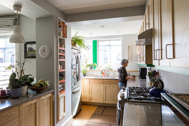 Mid-sized transitional galley cork floor open concept kitchen photo in Philadelphia with an undermount sink, shaker cabinets, light wood cabinets, granite countertops, gray backsplash, ceramic backsplash, stainless steel appliances and a peninsula