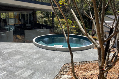 Photo of a small modern backyard round pool in Sydney with with a pool.