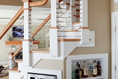 Design ideas for a mid-sized beach style wood u-shaped staircase in Providence with painted wood risers.