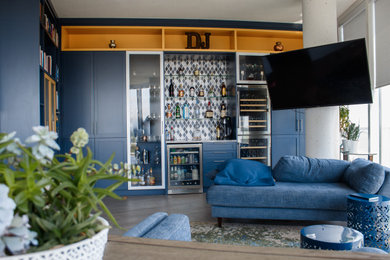 Living room library - transitional open concept living room library idea in Tampa with blue walls and no fireplace