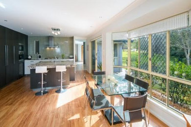 Photo of a contemporary kitchen in Brisbane with vinyl floors.