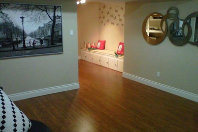 Inspiration for a mid-sized modern formal and open concept medium tone wood floor and brown floor living room remodel in Toronto with beige walls, no fireplace and no tv