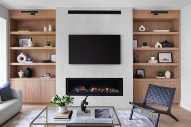 Example of a large danish open concept light wood floor living room design in Toronto with white walls, a standard fireplace, a stone fireplace and a wall-mounted tv