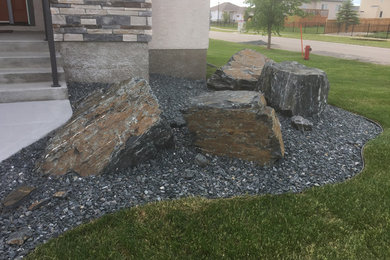 Design ideas for a modern rock front yard landscaping in Other for summer.