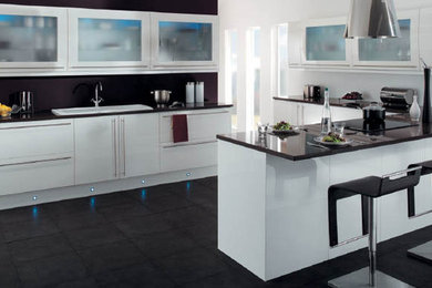 Inspiration for a modern u-shaped kitchen in Brisbane with a drop-in sink, flat-panel cabinets, white cabinets, granite benchtops, slate floors and no island.