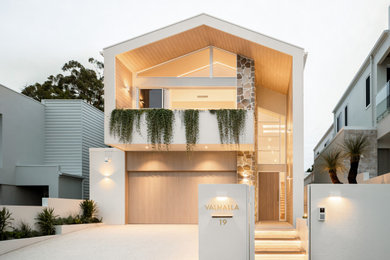 This is an example of a large contemporary two-storey house exterior in Brisbane.