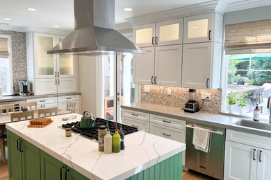 Inspiration for a large transitional kitchen remodel in Los Angeles with shaker cabinets, green cabinets, quartz countertops, stainless steel appliances, an island and multicolored countertops