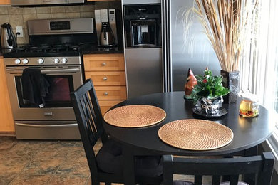 Eat-in kitchen - small contemporary l-shaped laminate floor and brown floor eat-in kitchen idea in Minneapolis with a double-bowl sink, recessed-panel cabinets, brown cabinets, granite countertops, brown backsplash, ceramic backsplash, stainless steel appliances and no island