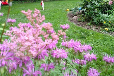 This is an example of a mid-sized transitional partial sun backyard garden path in New York for summer.