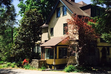Inspiration for a large farmhouse beige three-story stucco exterior home remodel in Philadelphia