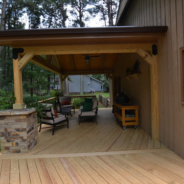 Raleigh Rustic Porch with Stone-Wrapped Columns and Decorative Brackets