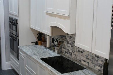 Huge transitional single-wall porcelain tile and gray floor eat-in kitchen photo in Richmond with an undermount sink, shaker cabinets, white cabinets, quartzite countertops, multicolored backsplash, stone tile backsplash, stainless steel appliances, an island and multicolored countertops