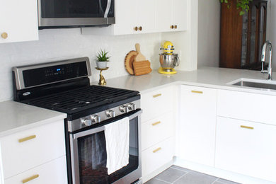 Mid-sized minimalist l-shaped ceramic tile kitchen photo in Philadelphia with an undermount sink, flat-panel cabinets, white cabinets, quartz countertops, white backsplash and stainless steel appliances