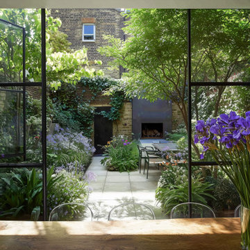Contemporary Chelsea Courtyard Garden with Lush Planting and Outdoor Fireplace
