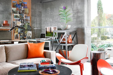 Small urban freestanding desk concrete floor home studio photo in Austin with gray walls