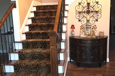 Inspiration for a mid-sized timeless wooden l-shaped metal railing staircase remodel in Other with painted risers