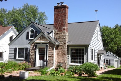 Example of a mid-sized classic gray one-story vinyl gable roof design in Other