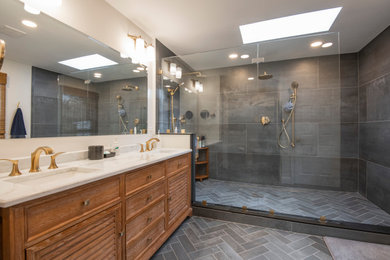 Large master beige tile cement tile floor, gray floor and double-sink bathroom photo in Philadelphia with louvered cabinets, brown cabinets, a one-piece toilet, beige walls, a drop-in sink, quartz countertops, white countertops and a built-in vanity