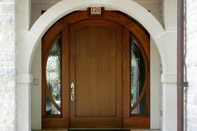 Inspiration for a transitional front door in St Louis with a single front door and a medium wood front door.